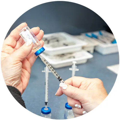 Nurse drawing allergen extract from a vial into a small syringe