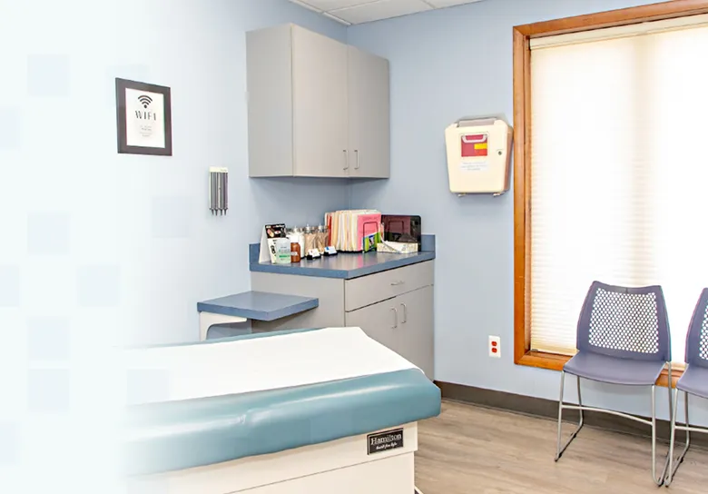 Bright exam room at Warren Allergy & Asthma Care with an exam table and window seating
