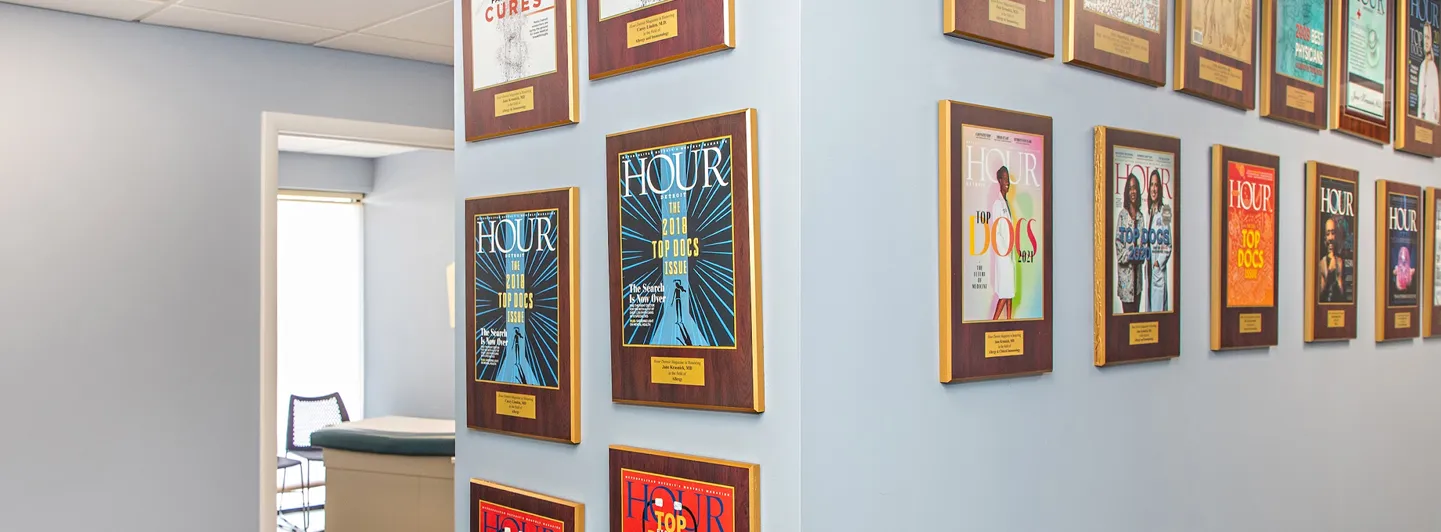 Hallway lined with framed magazine covers and awards